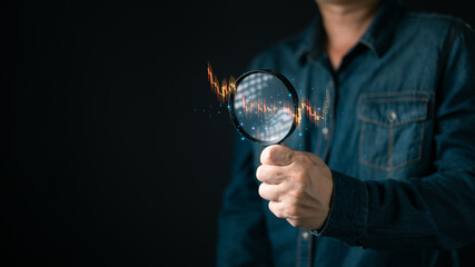 person hold a magnifying glass focused on digital candlestick chart with glowing data points,representing financial analysis,market research,investment strategies,and stock market performance review.