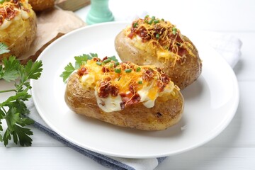 Tasty stuffed baked potatoes on white wooden table, closeup