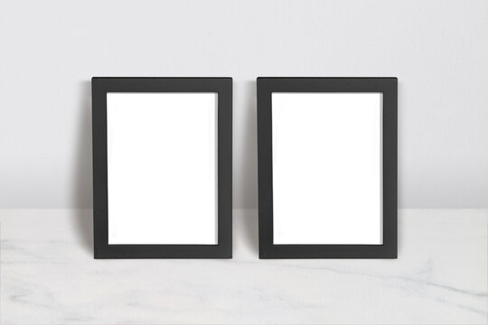 Poster Mockup with Two Black Frames on Marble Surface