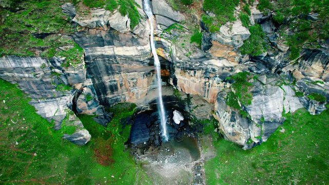 4K Aerial shot Para Lam waterfall in summer mountain valley at Suralbhatori, Pangi Valley, India. Powerful waterfall with crystal clear water from a melting glacier, flowing down. Beautiful landscapes