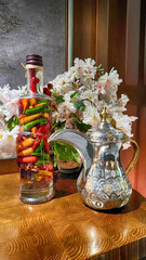 Pickles made in decorative glass jugs made of colorful vegetables on a wooden stand