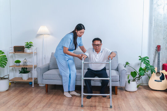 Caregiver Assisting Senior Man with Walker in Cozy Living Room Setting, Fostering Independence and Comfort in Daily Activities