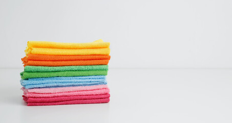 Household cleaning and hygiene concept. Colorful cleaning cloths neatly arranged, bringing brightness and energy to spring chores