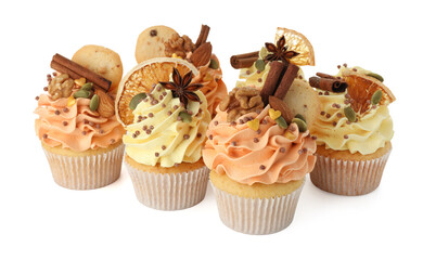 Delicious cupcakes with sprinkles, cookies, nuts and spices isolated on white. Autumn atmosphere