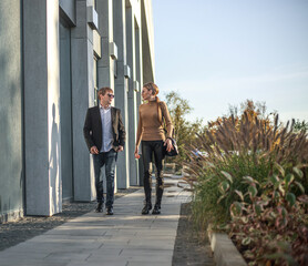 Business meeting of two partners and negotiations on work in the courtyard of business center