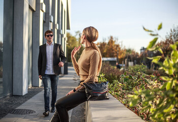 Business meeting of two partners and negotiations on work in the courtyard of business center