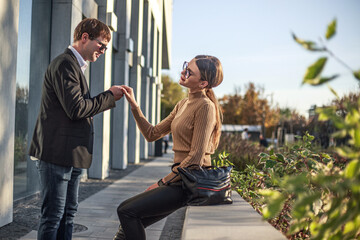 Business meeting of two partners and negotiations on work in the courtyard of business center