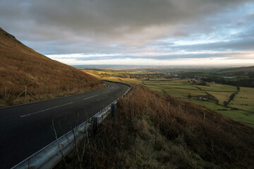 Evening Sun on the Crow Road. The B822 climbs into the Campsie Fells above Lennoxtown, East Dunbartonshire, Central Scotland, to a viewpoint at NS 612 801 giving extensive views to the east.