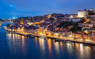 Panorama of the famous old town of Porto (Portugal) on the banks of the Douro River during the blue...