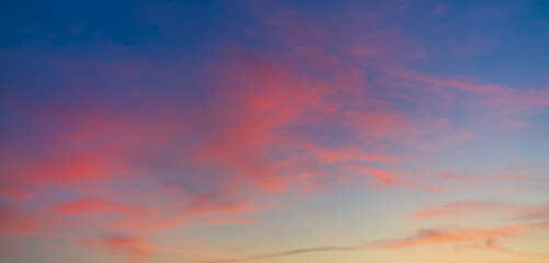 Dramatic purple and orange clouds fill the sky during either sunrise or sunset.