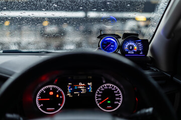 Digital and analog speedometer of racing cars,A close up of a speedometer inside a car, showing the speed dial reaching high numbers as the vehicle accelerates.
