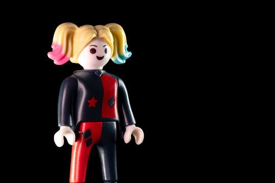 DC Harley Quinn standing sideways on a black background