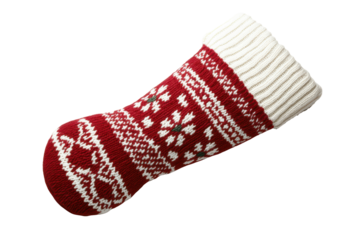 Red and white knitted christmas stocking with snowflake pattern isolated on transparent background. Traditional red and white christmas stocking with a fair isle pattern isolated on white background.