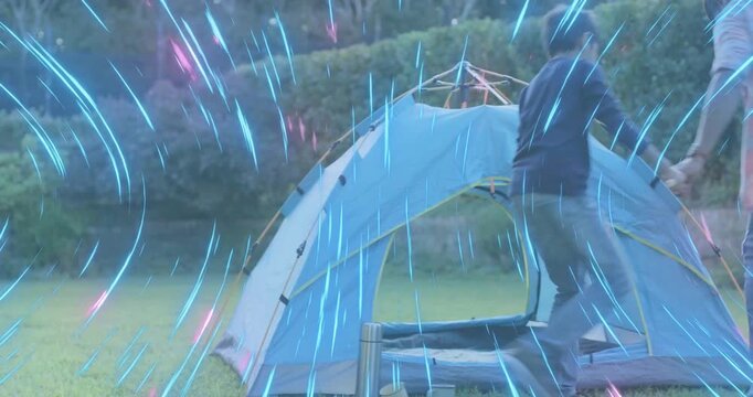 Father and son threading pole staking tent after son gripping corner triggers camping tent pitching