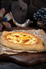 Adjarian Khachapuri with Egg and Cheese – Traditional Georgian Bread. Traditional Georgian Bread. Traditional Georgian cuisine styled with authentic atmosphere.