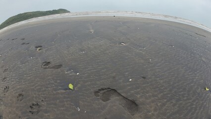 People's footprints in the sand