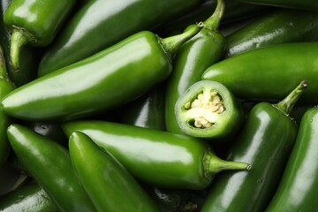 Fresh green jalapeno peppers as background, closeup