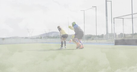 Attacker stepping dribbling orange ball around diving goalkeeper toward goal for hockey training - Powered by Adobe