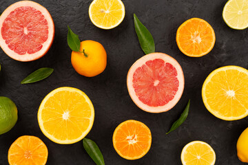 Different citrus fruits on concrete background, top view
