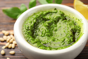 Fresh green pesto sauce on table, closeup