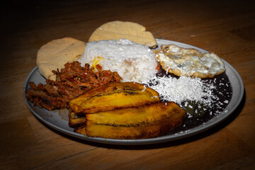Venezuelan Pabellon Criollo served on plate with rice, beans, beef and plantain