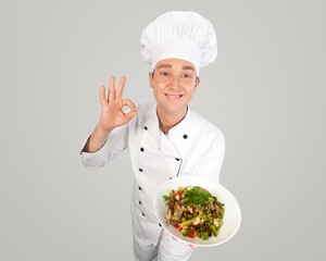 Happy young male chef wear uniform posing