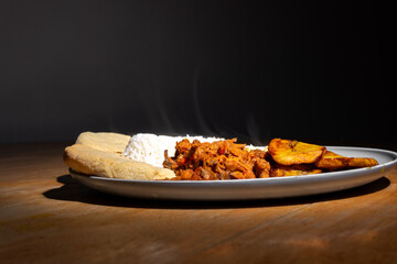 Traditional Venezuelan dish Pabellon Criollo with rice, black beans, shredded beef and fried plantain