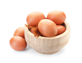 Raw chicken eggs in bowl and feathers isolated on white
