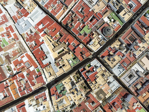 Fototapeta Aerial view of the sun-baked rooftops creating a mosaic of terracotta and ochre hues intersected by narrow streets, CÃ¡diz, Andalusia, Spain.
