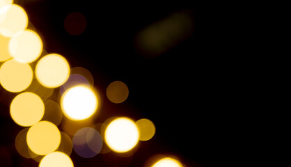 Bokeh lights in night blur. Golden yellow glow with dazzling sparkle, dreamy atmosphere, luminous