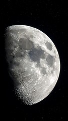 Close-up view of a gibbous moon against a star-filled night sky