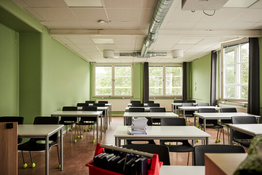 Empty classroom with desks and chairs in junior high school building