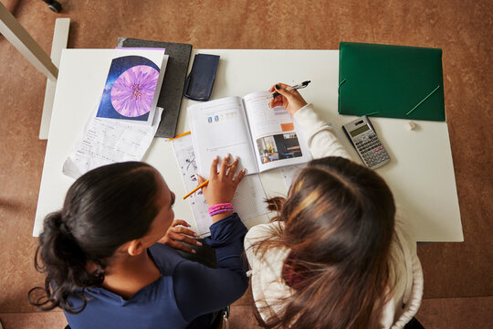High angle view of female junior high students studying in classroom at school