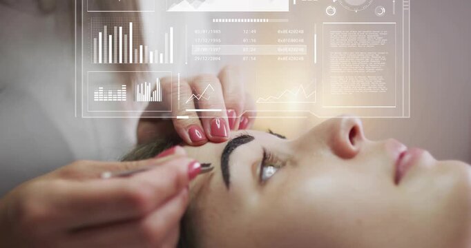Technician initiating salon treatment, shaping brows with tweezers while digital charts updating