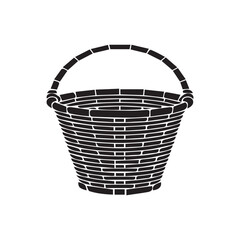 Isolated empty brown wicker basket with a handle, a natural woven craft object perfect for Easter, picnic, or shopping