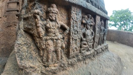 The Rich Texture and Fine Craftsmanship of Ancient Rock-Cut Reliefs Adorning a Wall in the Kanheri Cave Complex, Evoking Spiritual Heritage.