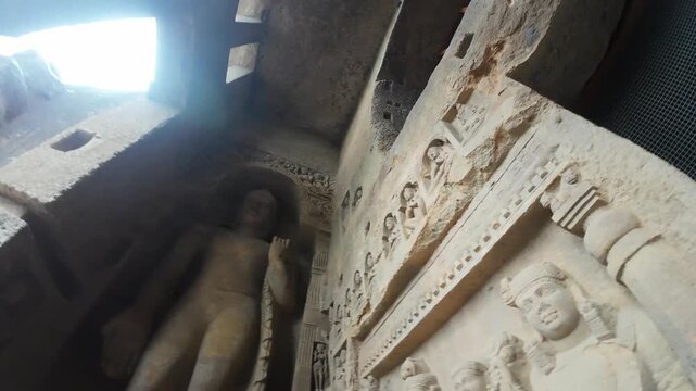 Detailed View of a Life-Sized Buddhist Sculpture Showcasing Ancient Indian Craftsmanship and Detailed Drapery within the Kanheri Cave Complex, Maharashtra