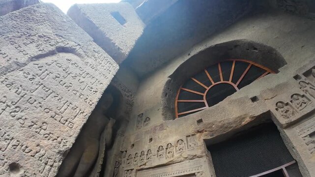 The Grand Exterior of Cave Three at Kanheri Caves, Showcasing Monumental Rock-Cut Pillars, Intricate Carvings, and Historical Calligraphy