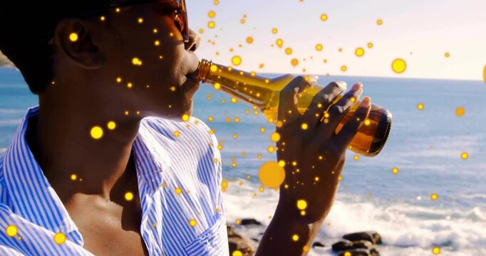 brand ad featuring woman adjusting bottle grip on coast releasing golden sparkles and sipping drink
