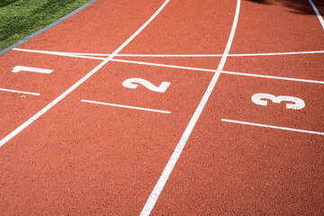 Start and numbers on the stadium track, running, sports.
