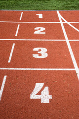 Start and numbers on the stadium track, running, sports.
