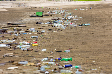 Discarded single-use plastic bottles and rubbish washed up on a remote coastline