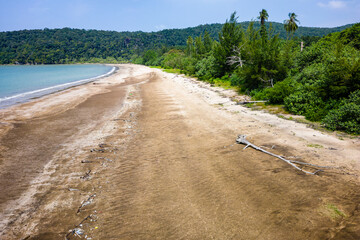Aerial drone view of plastic garbage and debris washed ashore on a remote sandy beach