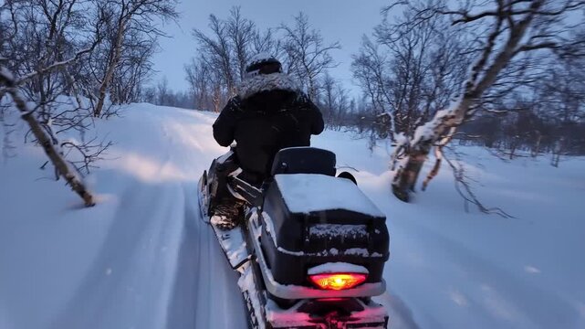 People operating snowmobile on rural countryside road in the winter.	
