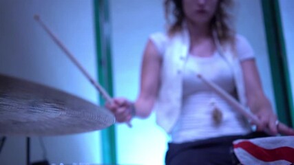 beautiful young woman plays the drums in slow motion - Powered by Adobe