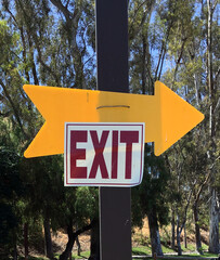 EXIT direction signage at a rural parking lot