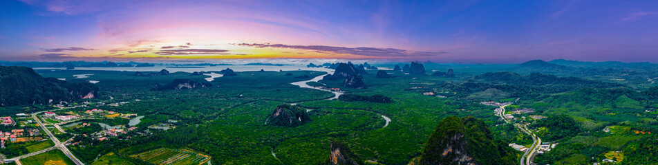 Fototapeta premium Scenic panorama landscape of phang nga Thailand at sunset with lush greenery and limestone formations