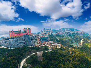 Fototapeta premium Aerial view of ba na hills with vibrant architecture castle and french village in Da nang, Vietnam