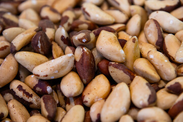 Close-up Many delicious Brazil nuts as background, top view. A backdrop for advertising nuts and dried fruits.