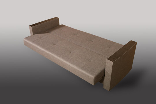 Isolated sofa bed with fabric upholstery on grey gradient background.